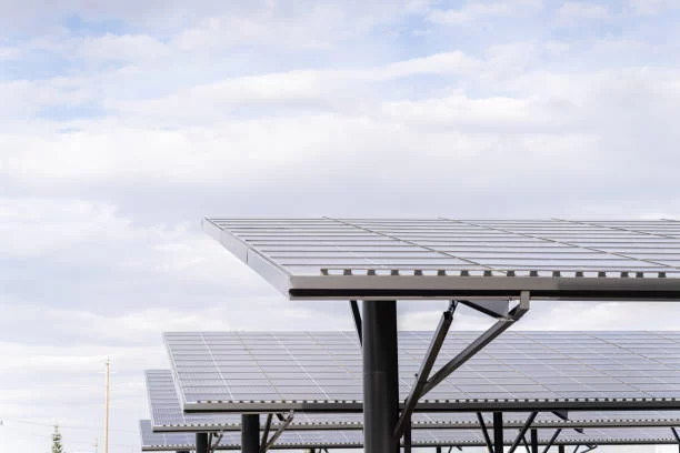 Paneles solares captando energía luminosa para generar electricidad en un área rural.